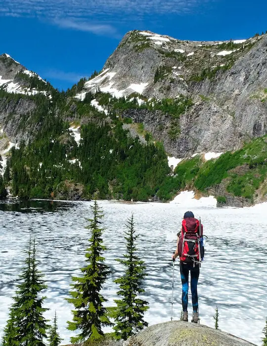A-Woman-Hiker-Looking-at-Frozen-Thorton-Lake-and-Trappers-Peak.-North-Cascades-National-Park-Washington