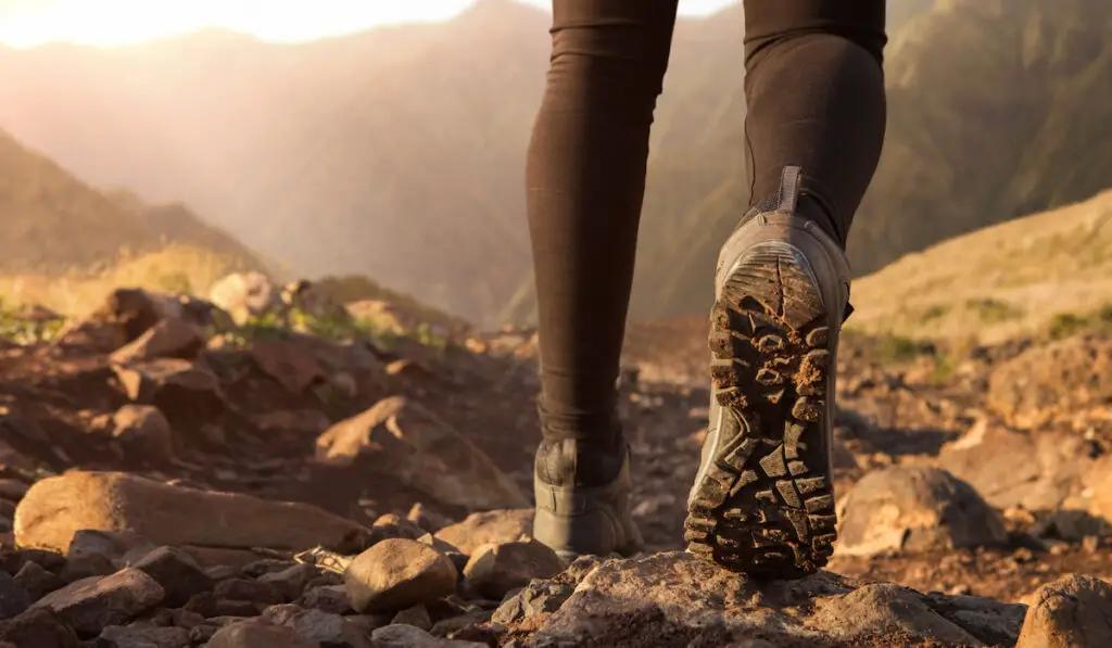 Close up of hiker boots running in the mountains