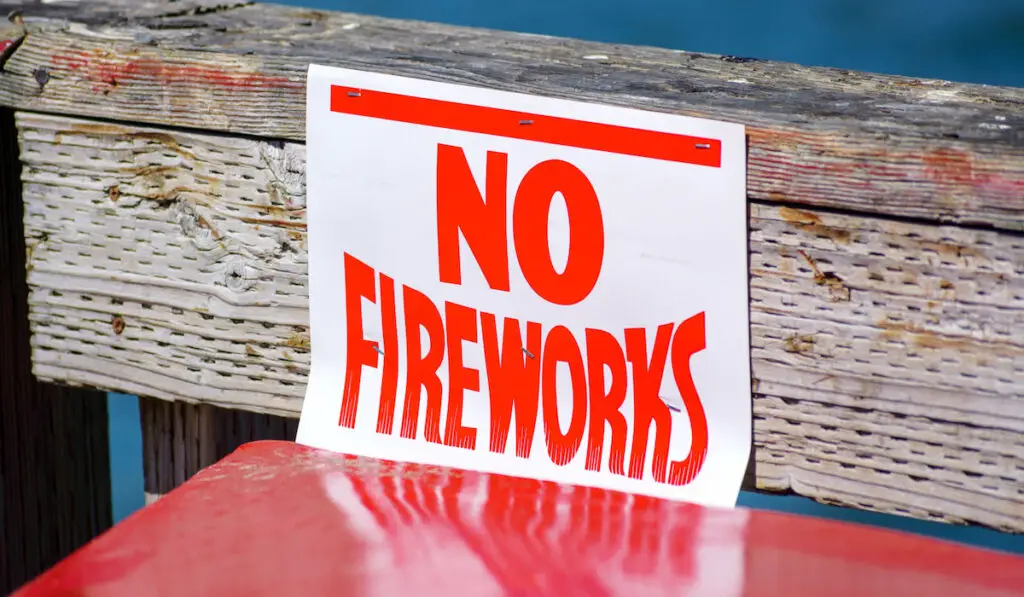 No fireworks sign on the wooden fence