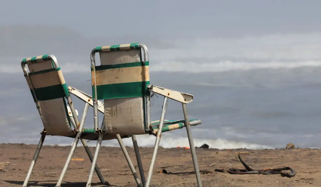 Old Camping chairs on the beach overlooking the Atlantic Ocean 