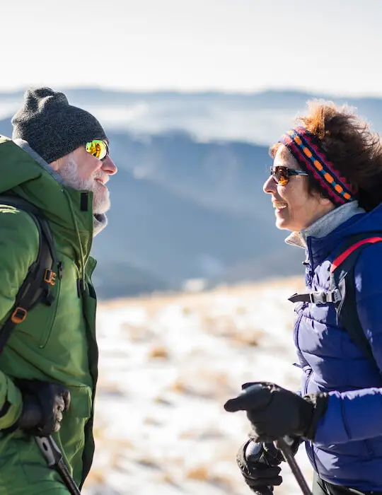 couple-hikers-talking-in-snow-covered-winter-nature