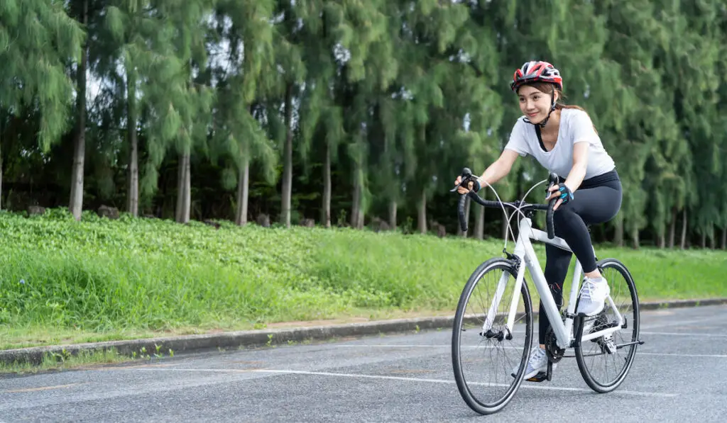 sport woman riding bicycle in the public park.