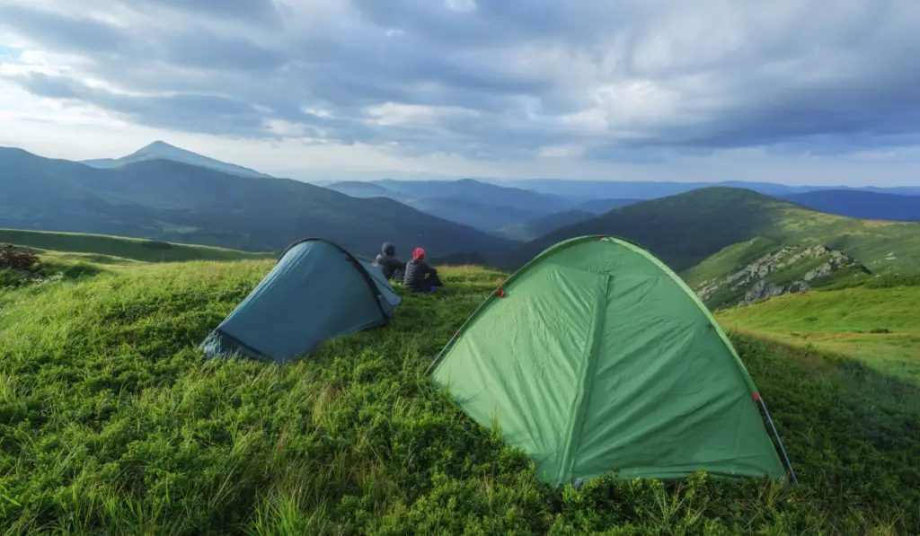 green tent on mountains closeup

