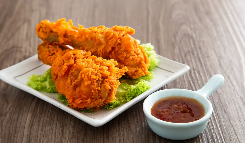 crispy and golden fried chicken with dipping sauce

